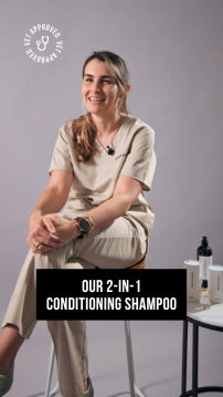 Vet sitting with a product setup on a table, featuring '2-in-1 Conditioning Shampoo' text.